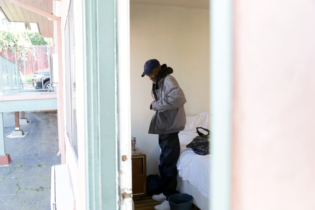 ALISSA AMBROSE/STAT--Foreman prepares to leave his room at an East Oakland motel, where he stayed for one night to escape the cold.