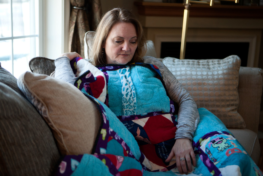 Portsmouth, NH -- 01/21/16 -- Paula Skelley, mother of Lydia Valdez, poses for a portrait with a "memory quilt" made from Lydia's pajamas and bathrobe, in her home on January 21, 2016, in Portsmouth, New Hampshire. (Kayana Szymczak for STAT)